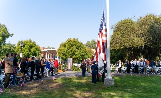 Flag being raised by those in military uniform
